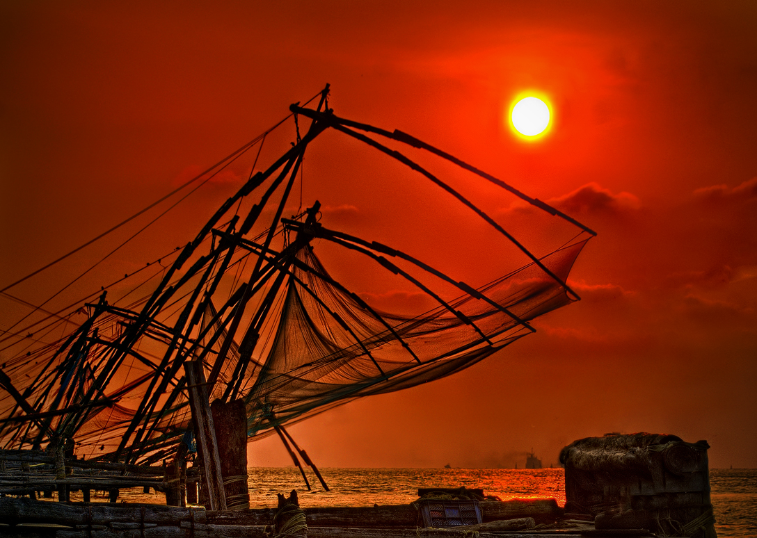 The sun looming over Chinese fishing nets in Kerala
