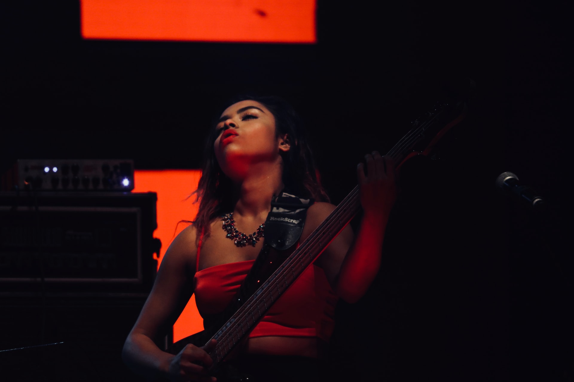 An Indian bass guitarist at a concert.